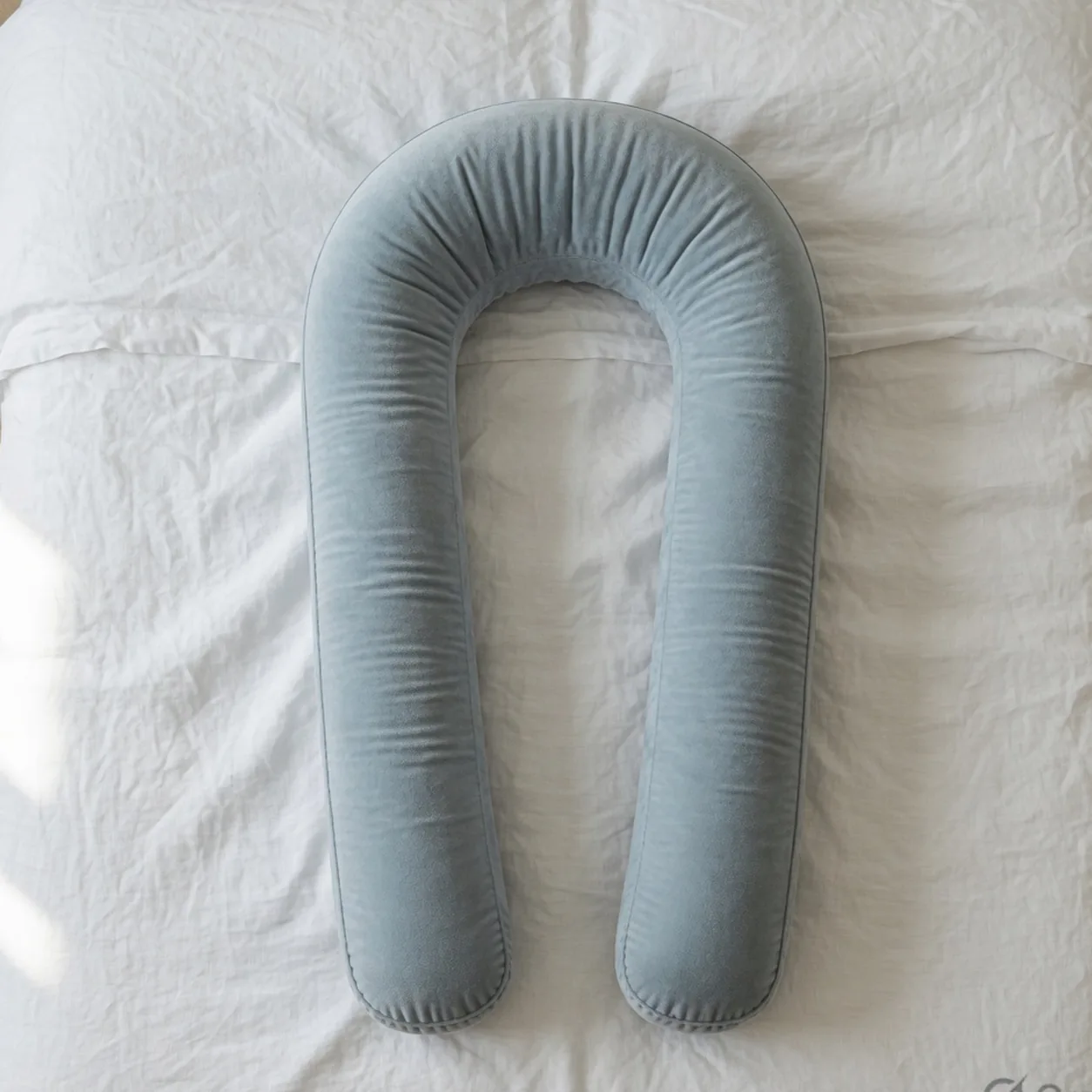 Overhead view of the empty U on a bed — the channel you lie in